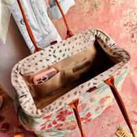 Atenti Gemma Molly handbag with vintage-inspired floral print, rust-colored double handles, spotted frame trim, and organized lined interior