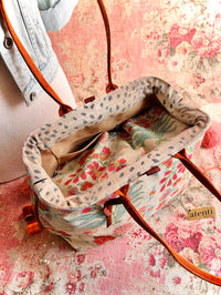 Atenti Gemma Molly handbag with vintage-inspired floral print, rust-colored double handles, spotted frame trim, and organized lined interior