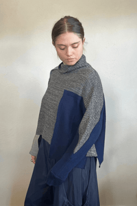Moyuru 46332G Grey Combo pullover sweater with asymmetric grey and deep blue knit panels