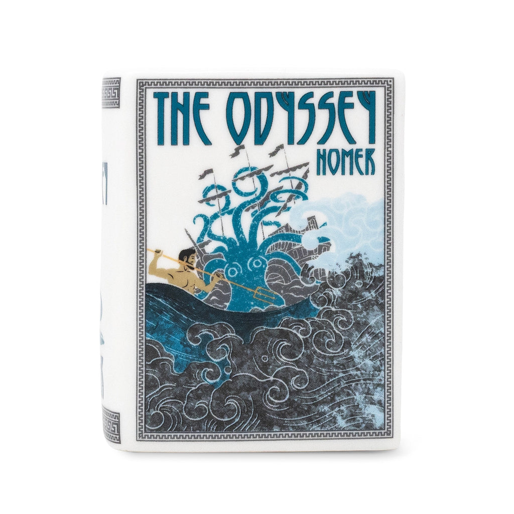 Steel Mill & Co. The Odyssey Book Candle in decorative ceramic book-shaped vessel, showing artwork, sides, and lit candle