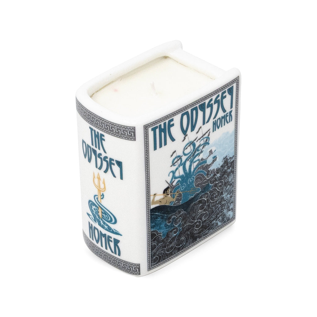 Steel Mill & Co. The Odyssey Book Candle in decorative ceramic book-shaped vessel, showing artwork, sides, and lit candle