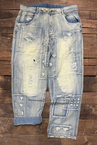 Jaded Gypsy Denim Peace And Love Jeans with distressed patchwork details, faded blue wash, embroidered back design, and rolled cuffs