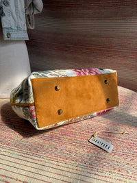 Atenti Primrose Molly handbag with oversized floral print, caramel-colored double handles and base, and structured snap-frame silhouette