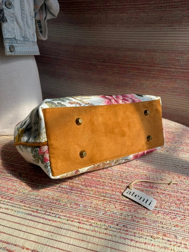 Atenti Primrose Molly handbag with oversized floral print, caramel-colored double handles and base, and structured snap-frame silhouette