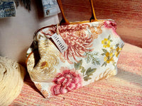 Atenti Primrose Molly handbag with oversized floral print, caramel-colored double handles and base, and structured snap-frame silhouette