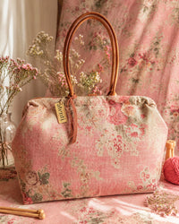 Atenti Rosewood Pioneer handbag with faded rose print, caramel double handles and piping, and contrasting caramel base with metal feet