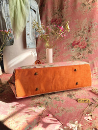 Atenti Rosewood Pioneer handbag with faded rose print, caramel double handles and piping, and contrasting caramel base with metal feet