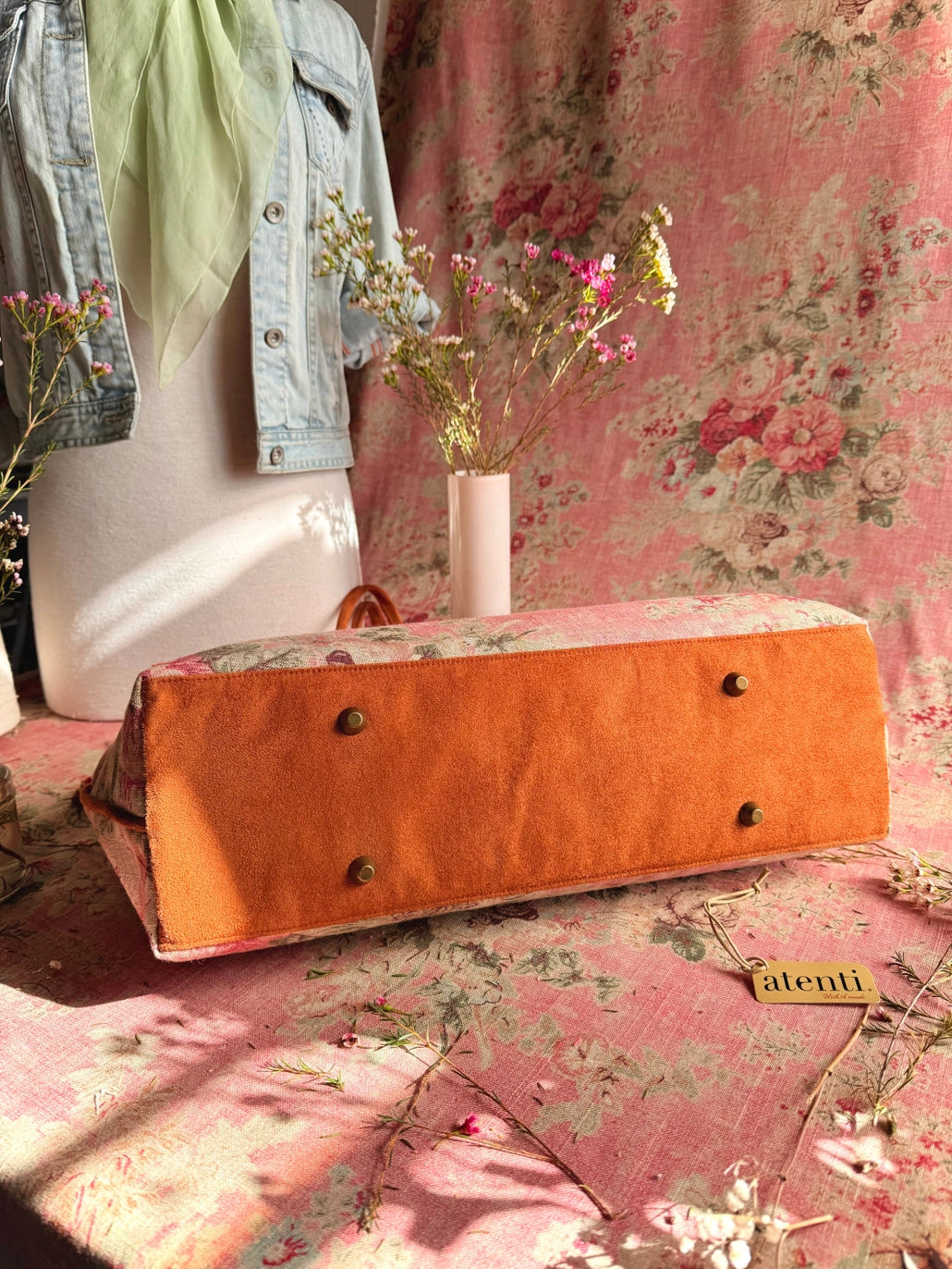 Atenti Rosewood Pioneer handbag with faded rose print, caramel double handles and piping, and contrasting caramel base with metal feet