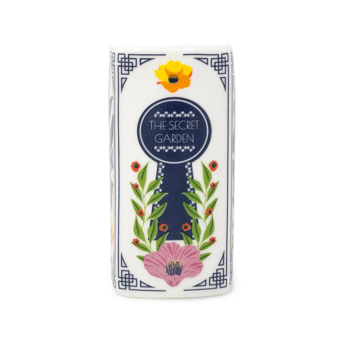 Steel Mill & Co. The Secret Garden Book Candle featuring colorful botanical illustrations in a ceramic book-shaped vessel