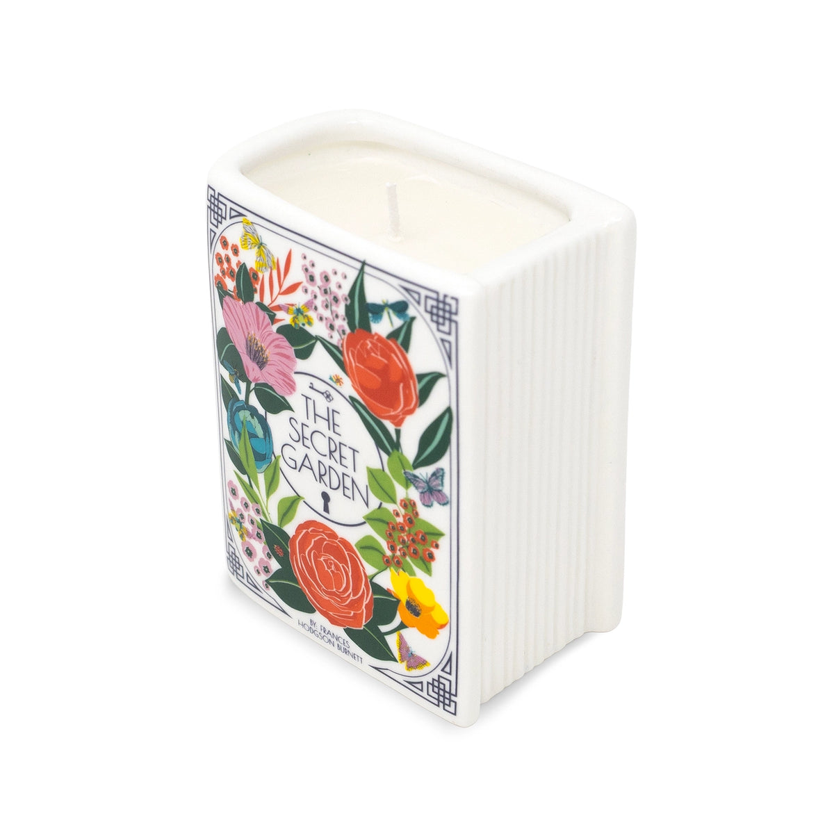 Steel Mill & Co. The Secret Garden Book Candle featuring colorful botanical illustrations in a ceramic book-shaped vessel