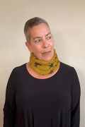 Paper Temples Star Knitted Neck Piece in mustard with charcoal print worn as a neck warmer