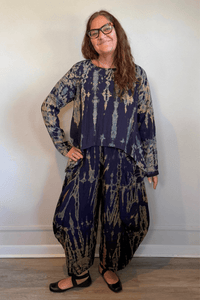 Gertie's 1073Hd Topper in a deep indigo hand-dyed pattern with sage, teal, ochre and muted plum accents, featuring long sleeves, a relaxed silhouette and asymmetrical handkerchief-style hem.